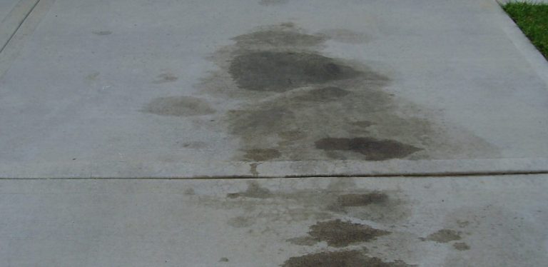 oil stain on concrete A dark black stain on concrete could be an oil stain.